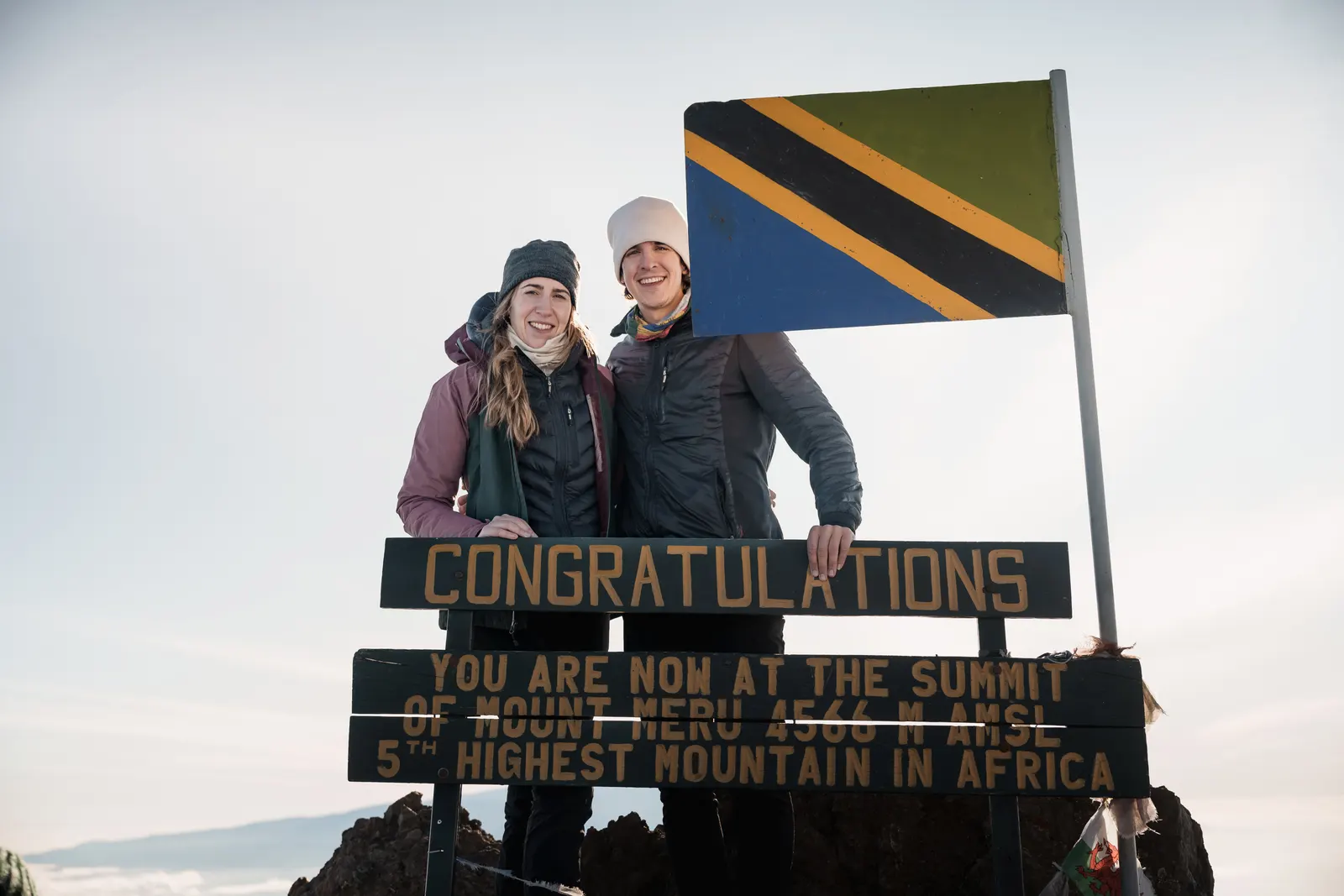 Climbers at the Mount Meru summit sign, Arusha National Park