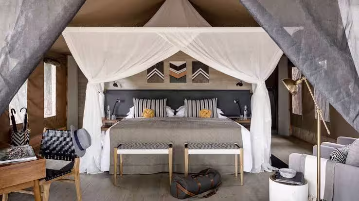 A tented suite bedroom at Sanctuary Swala Camp