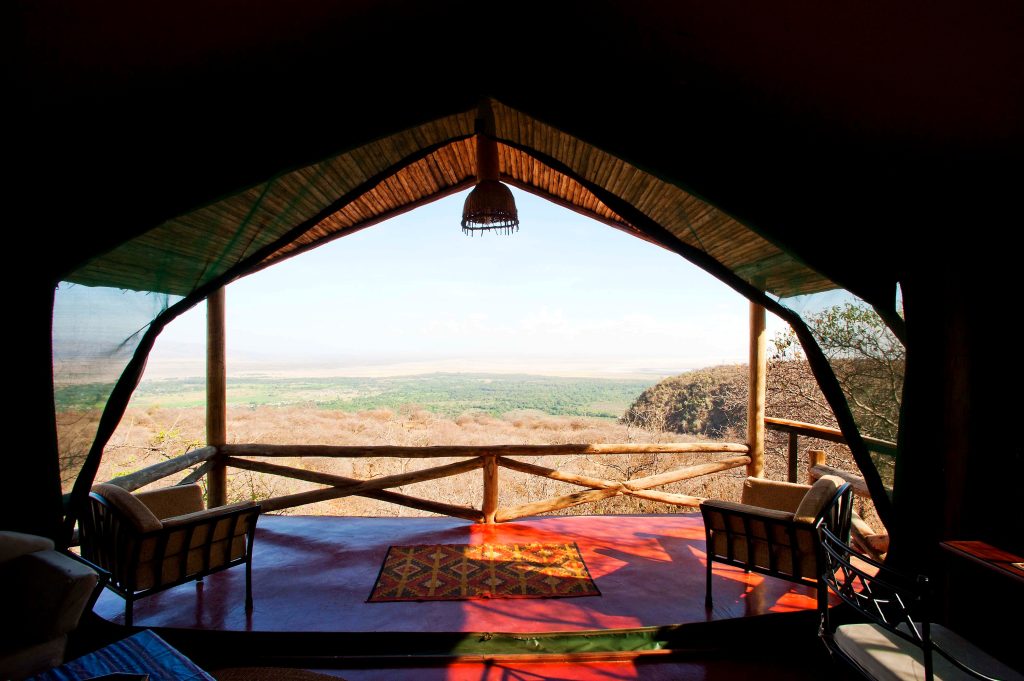 Kirurumu Manyara Lodge: View from inside a tent across its veranda to the Rift Valley escarpment and Lake Manyara plains