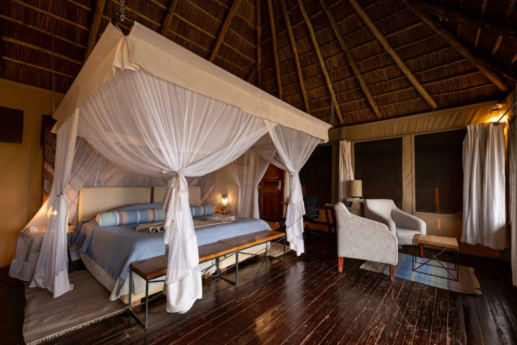 Kubu Kubu Tented Lodge: Tent interior with mosquito-net canopy bed under a thatched roof